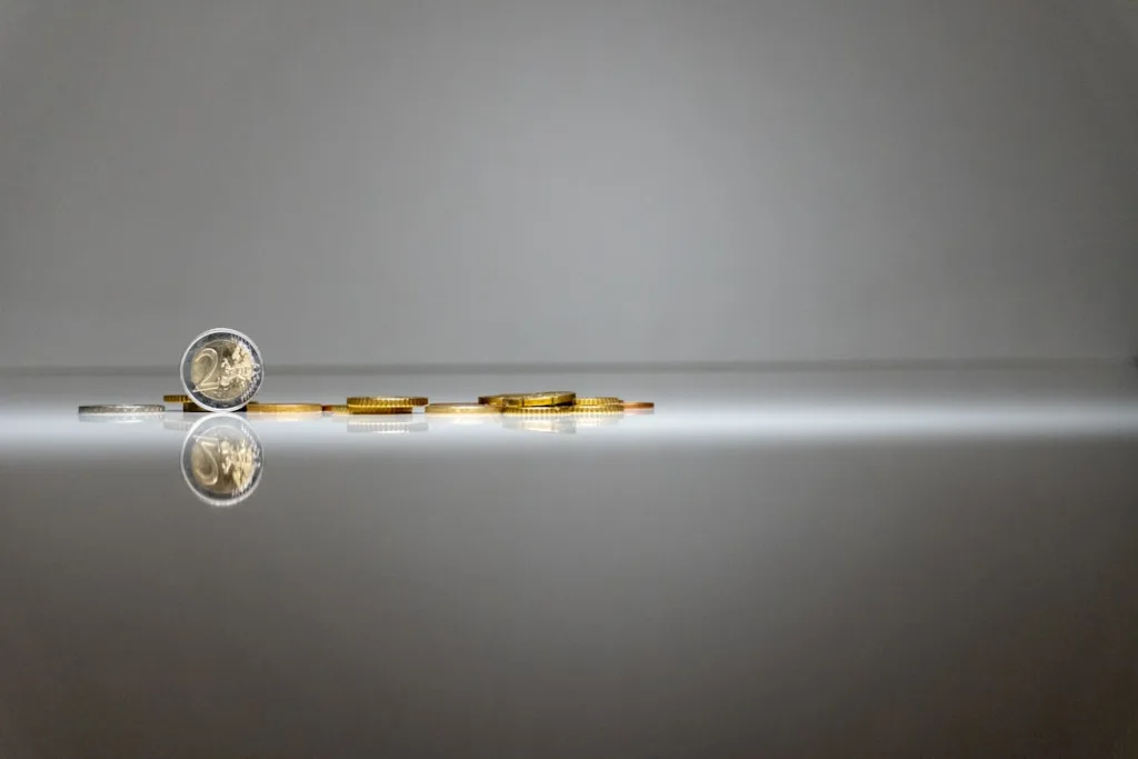 Stacked coins on a reflective surface, symbolizing budgeting and cost estimation for a bathroom renovation.