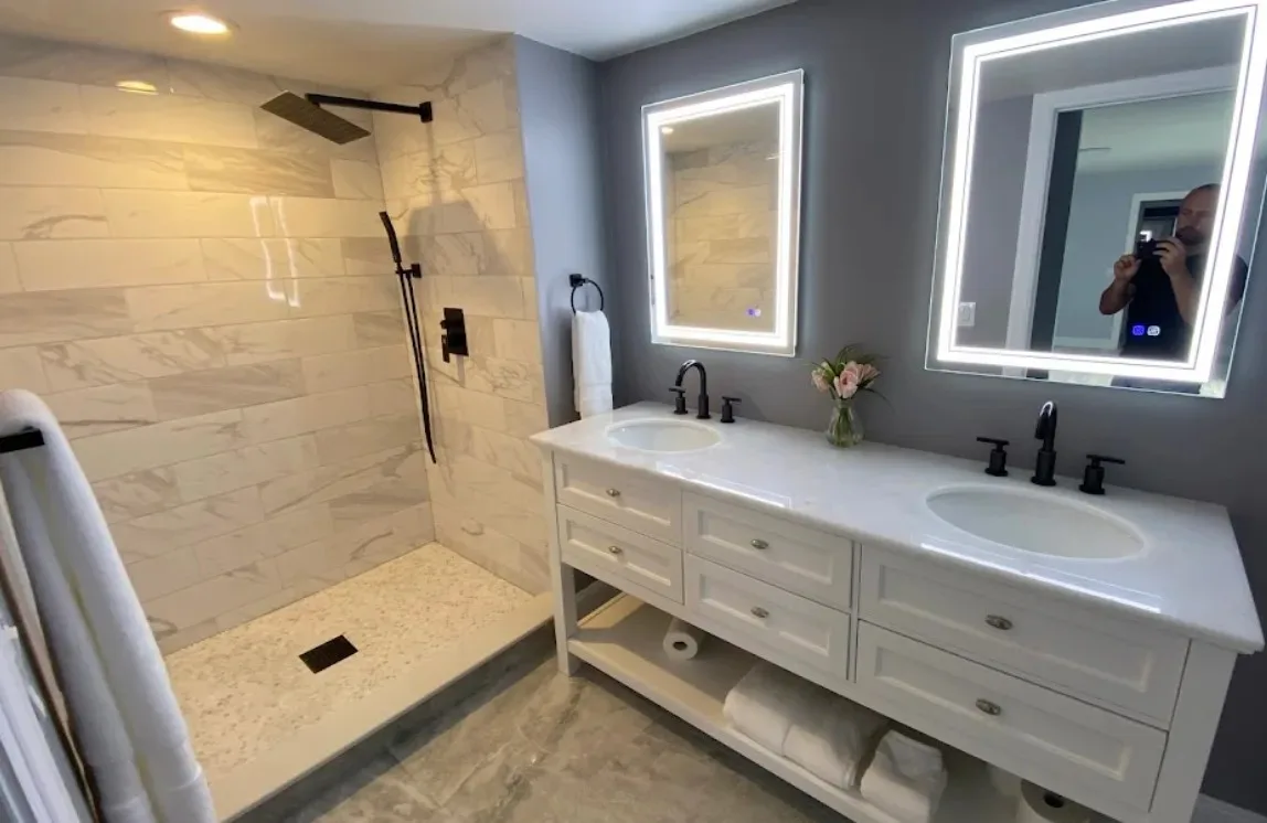 Modern bathroom with double sink vanities and a large walk-in shower.