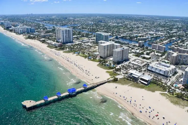 Aerial view of Tamarac, FL cityscape with river and skyline