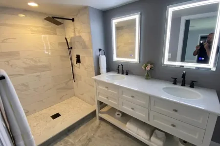 Modern bathroom with double sink vanities and a large walk-in shower.